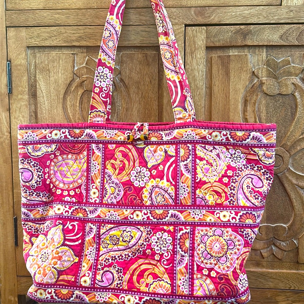 Vera Bradley tote bag with button closure and inside zipper pocket.
